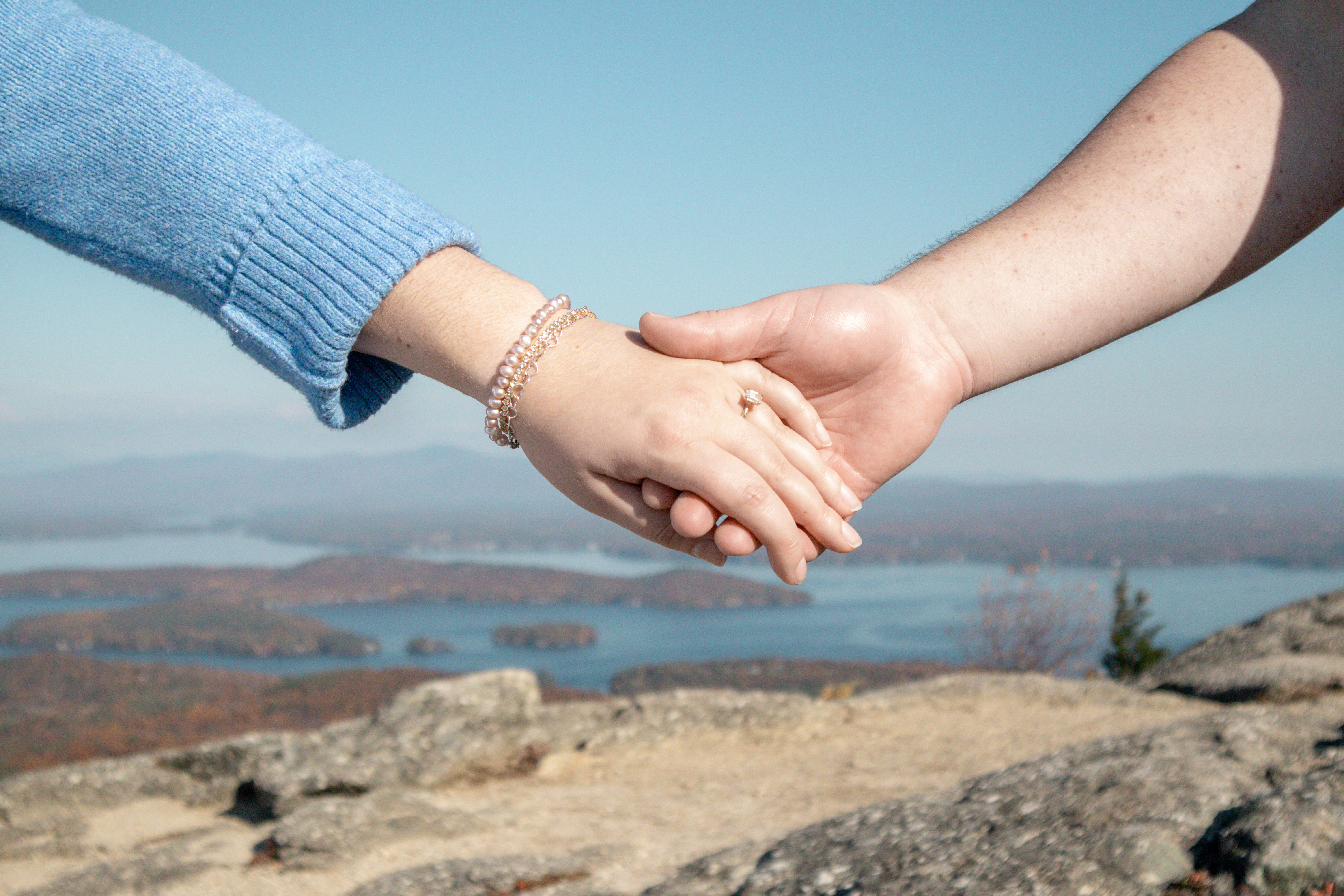 Kayla and Peter holding hands on top of Mount Major.